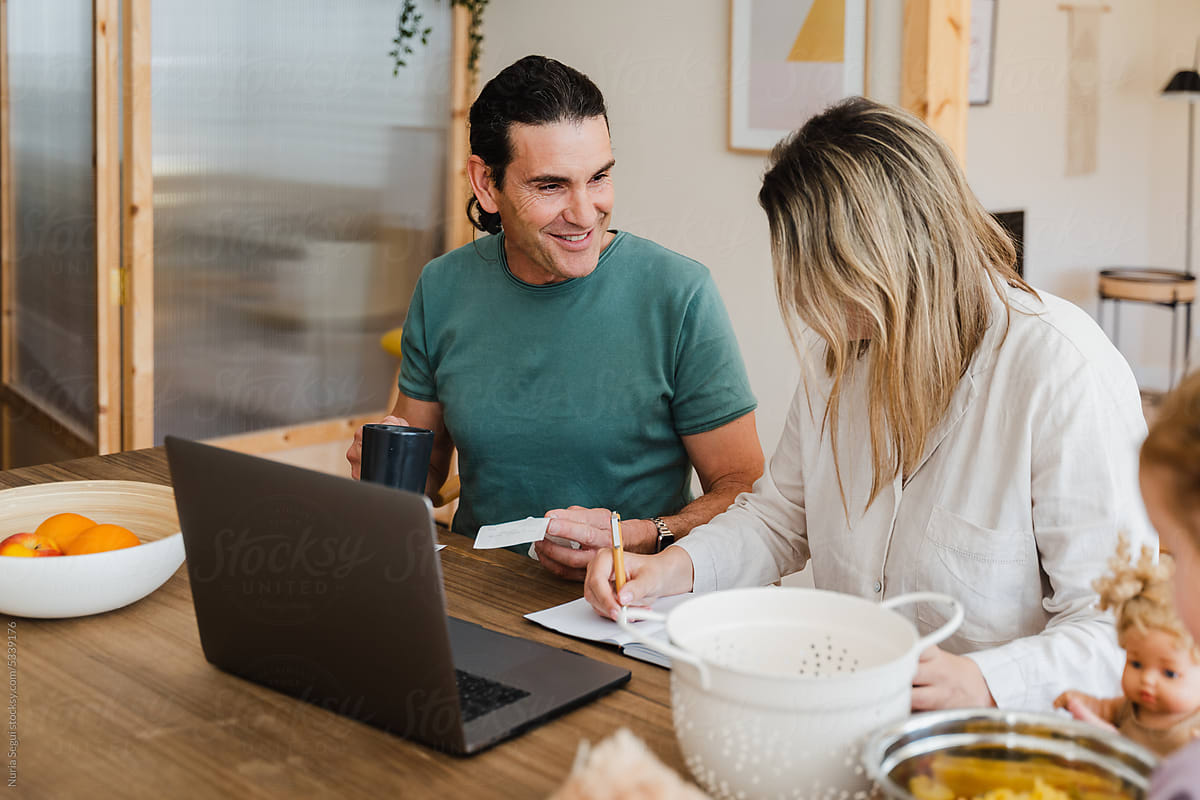 Cheerful Couple Paying Bill At Home