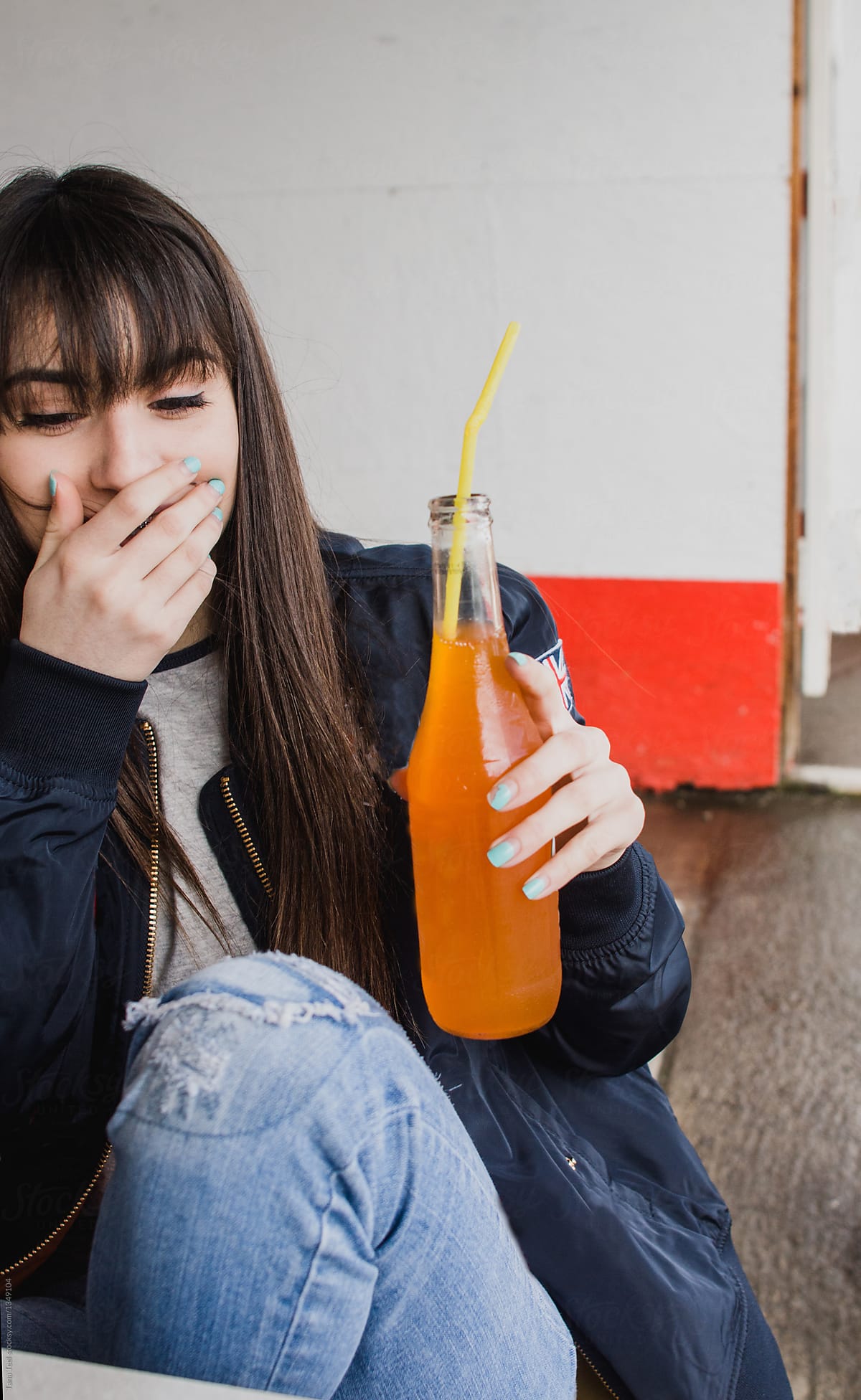 teenager drinking orange soda pop