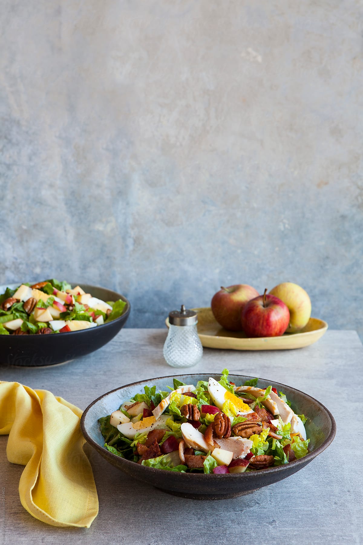 salad with chicken, egg,  bacon apple and nuts