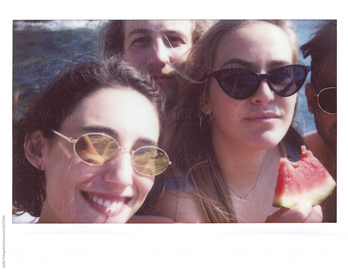 Polaroid photo of friends eating watermelon.