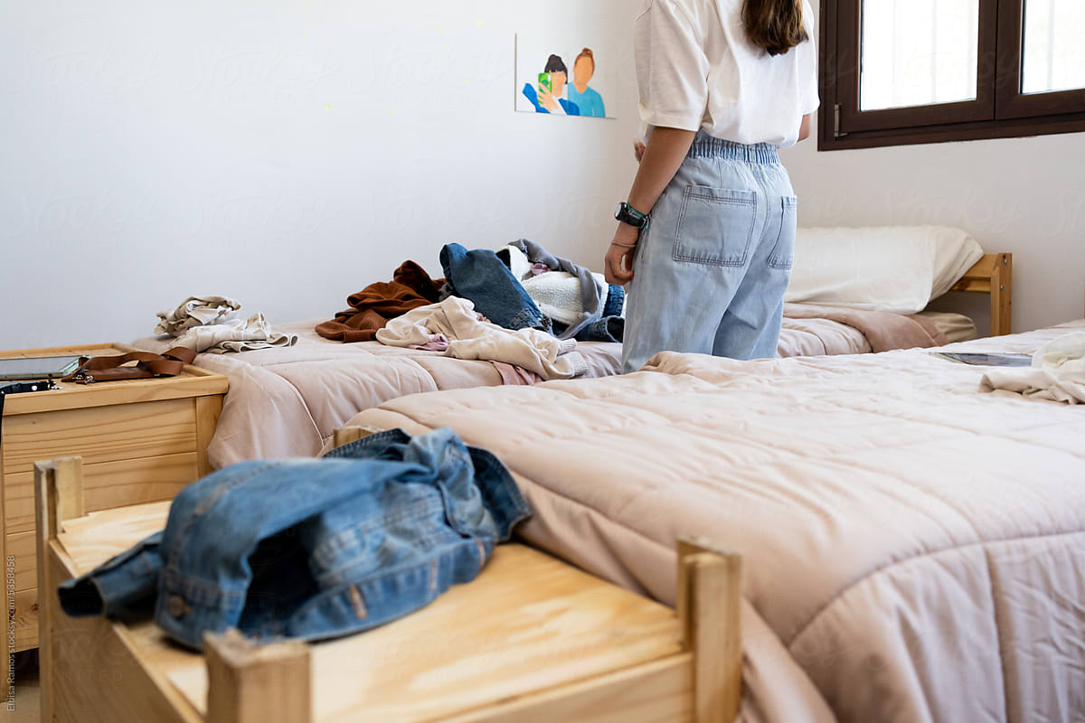 Girl sorting clothing in her bedroom