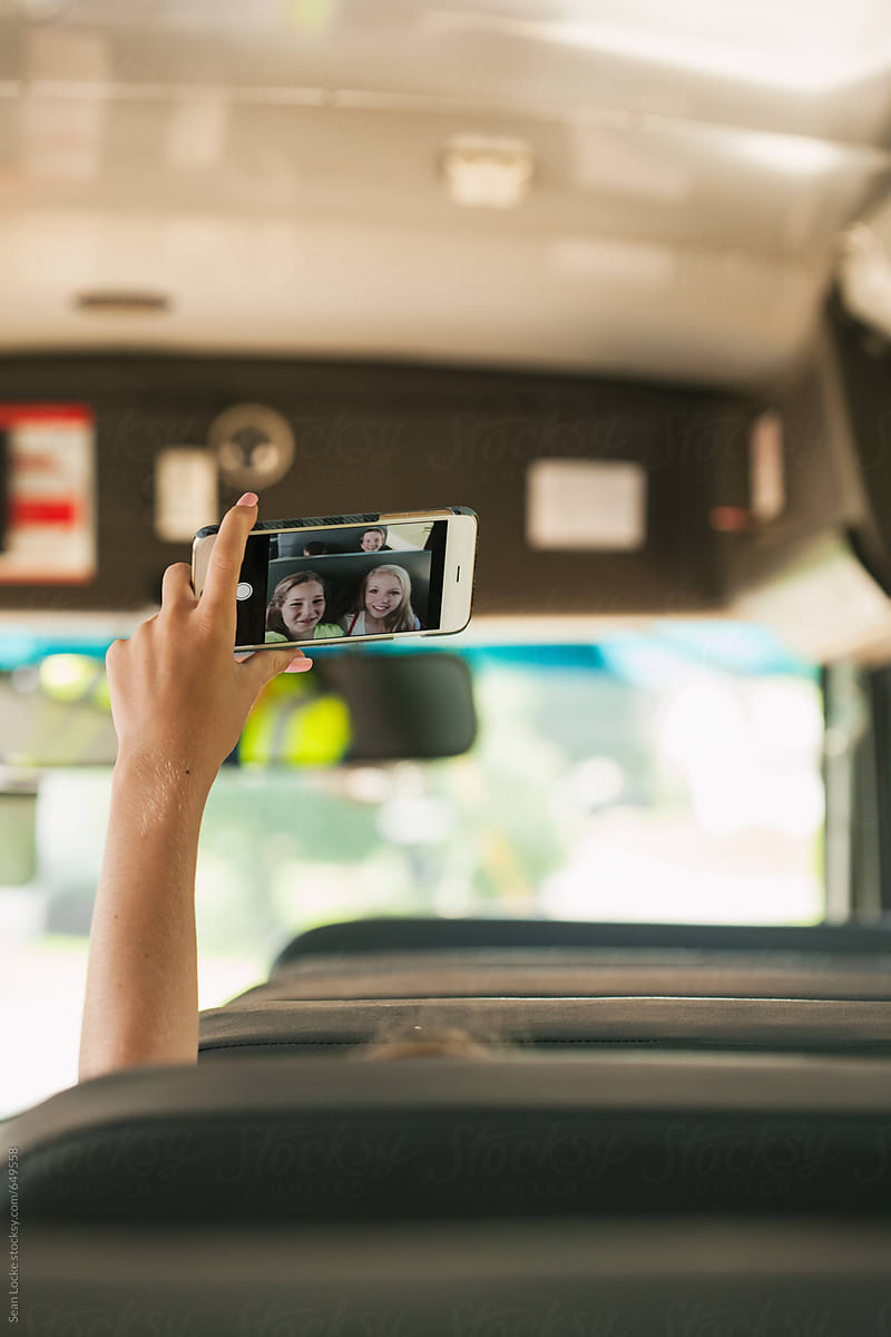 School Bus: Girl Holds Up Phone To Take Selfie