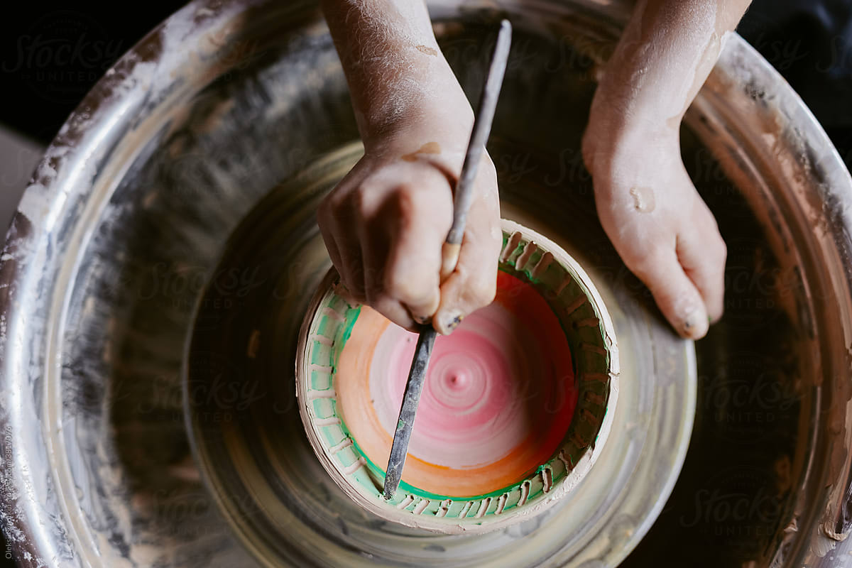 Ceramist decorating pinch pot
