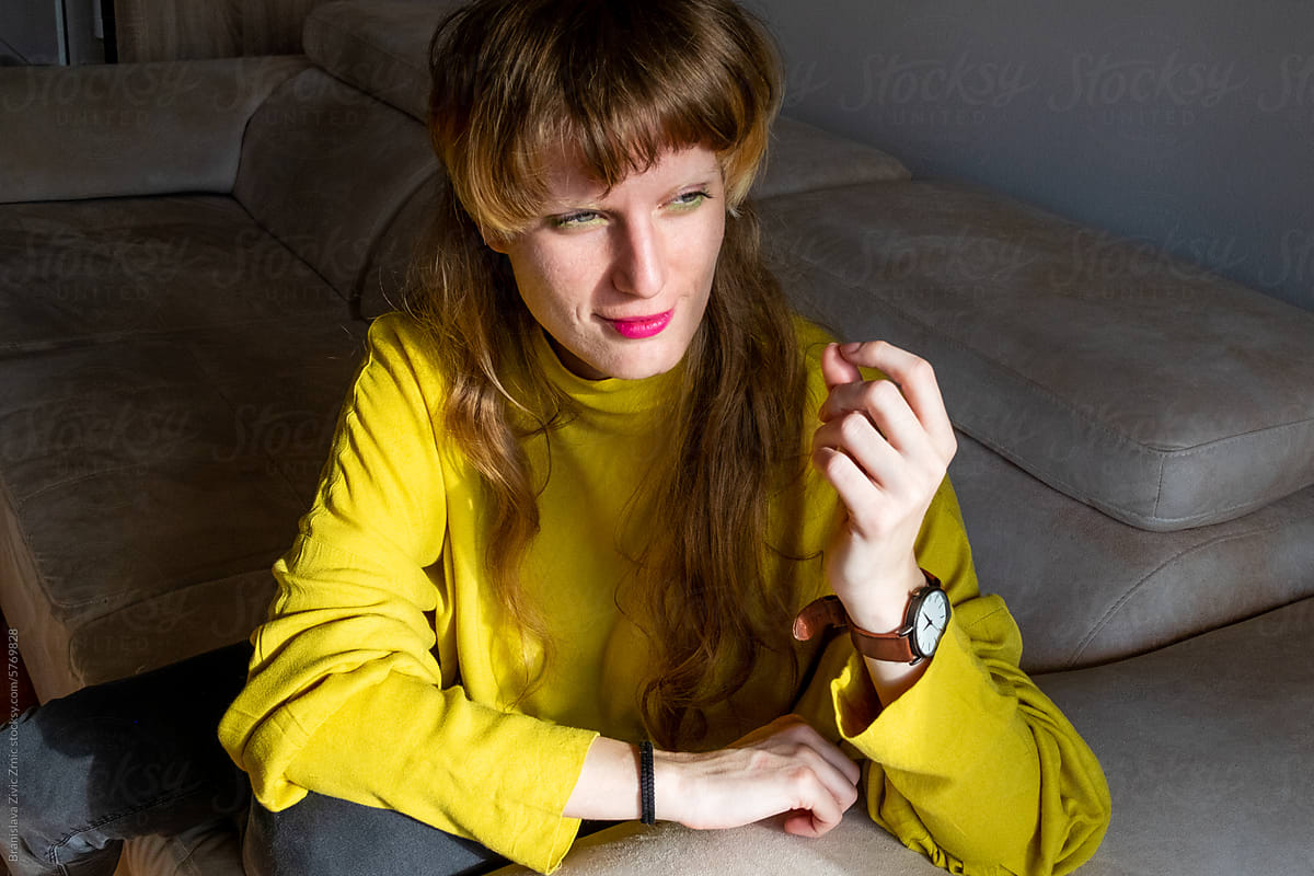 Portrait of a female sitting on the sofa at home