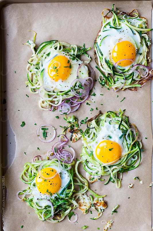 Spiralized zucchini nests with eggs by Nadine Greeff - Stocksy United