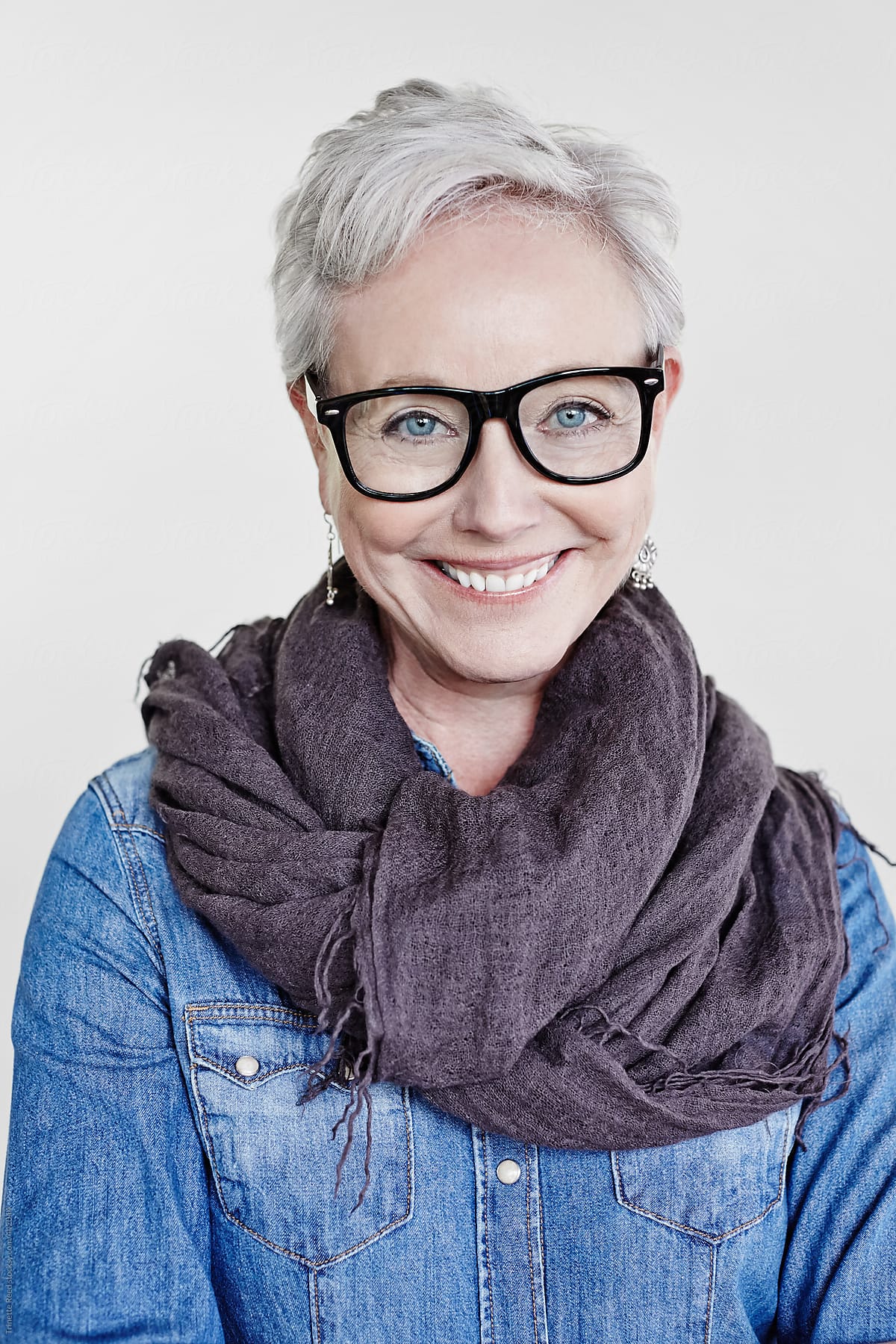 Studio portrait of happy mature woman with grey hair