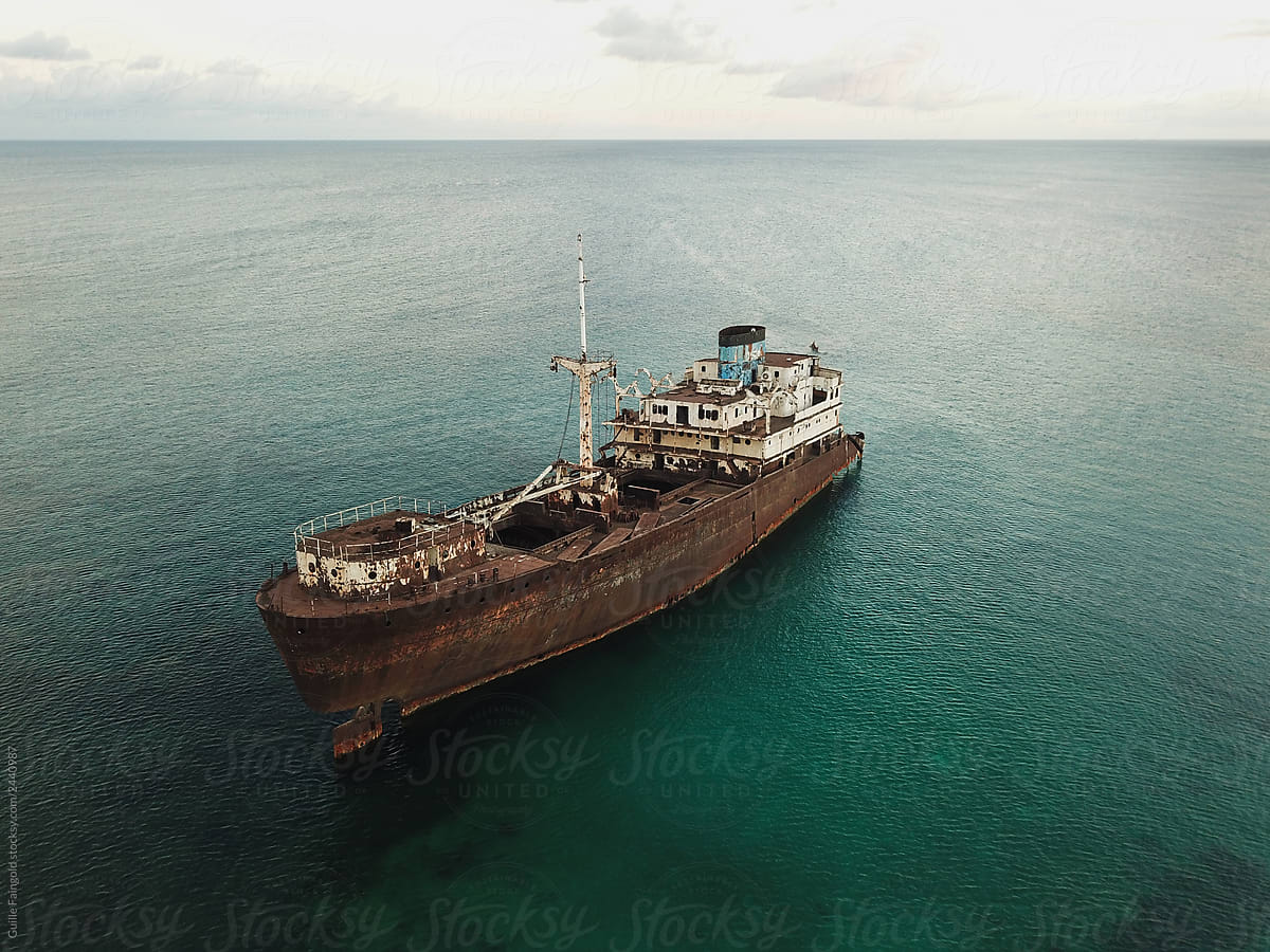 Rusty ship on ocean shoreline