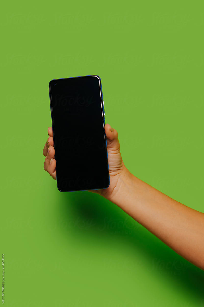Crop person showing smartphone with blank black screen