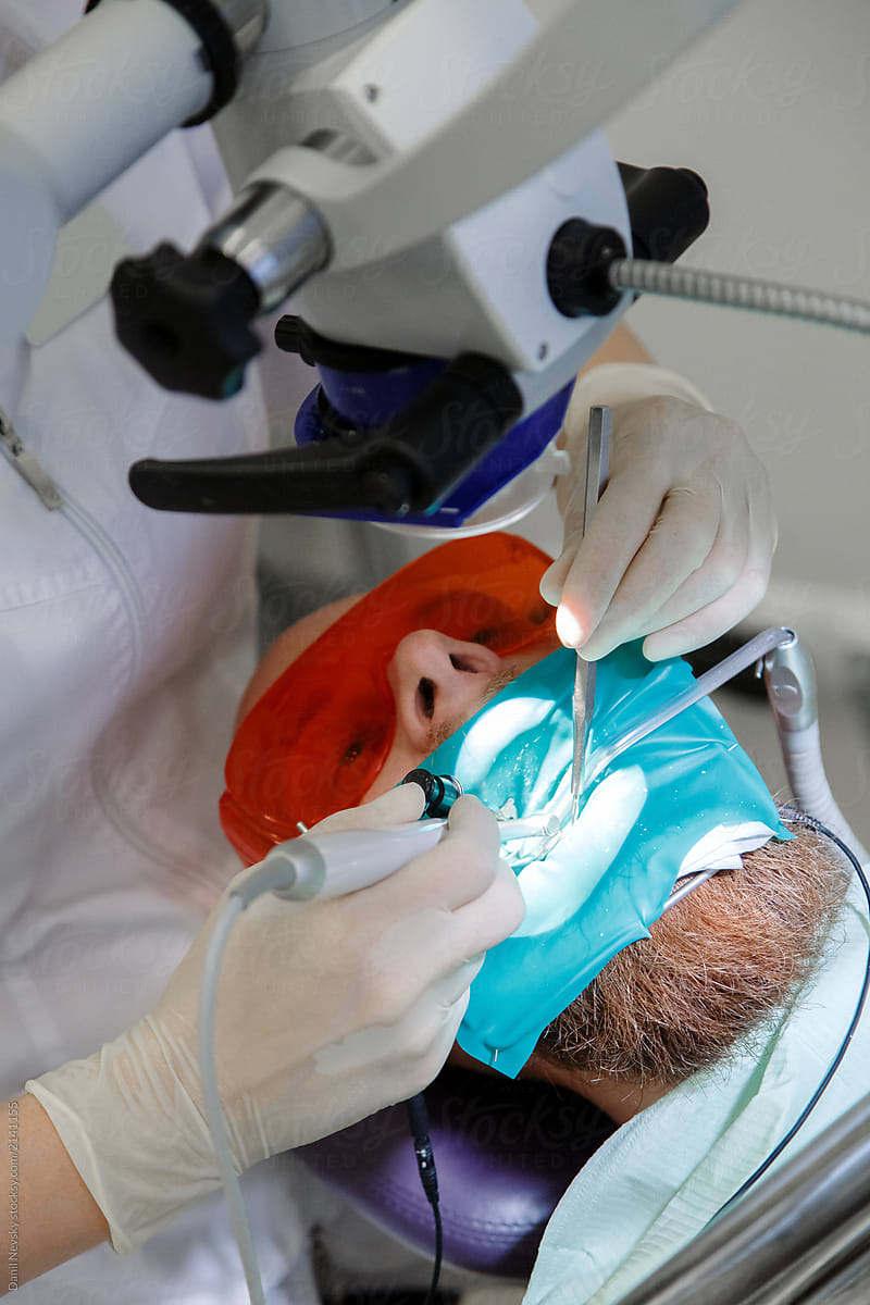 Dentist operating man in hospital