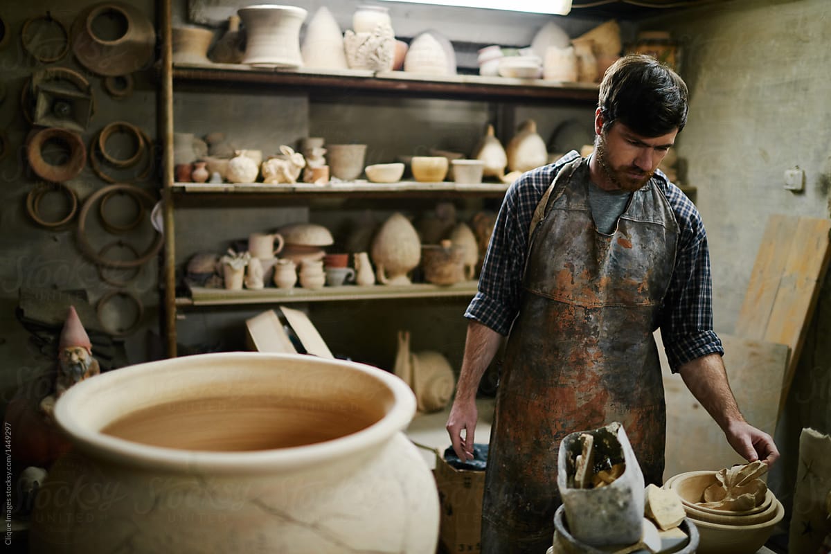 Talented artisan selling  beautiful ceramics in small pottery sh