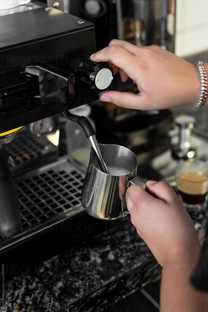 Female barista making coffee at espresso machine