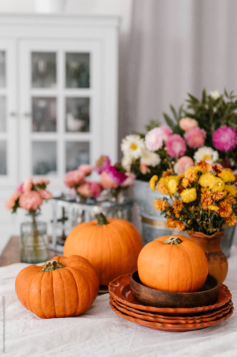 Flowers and pumpkins in dining room