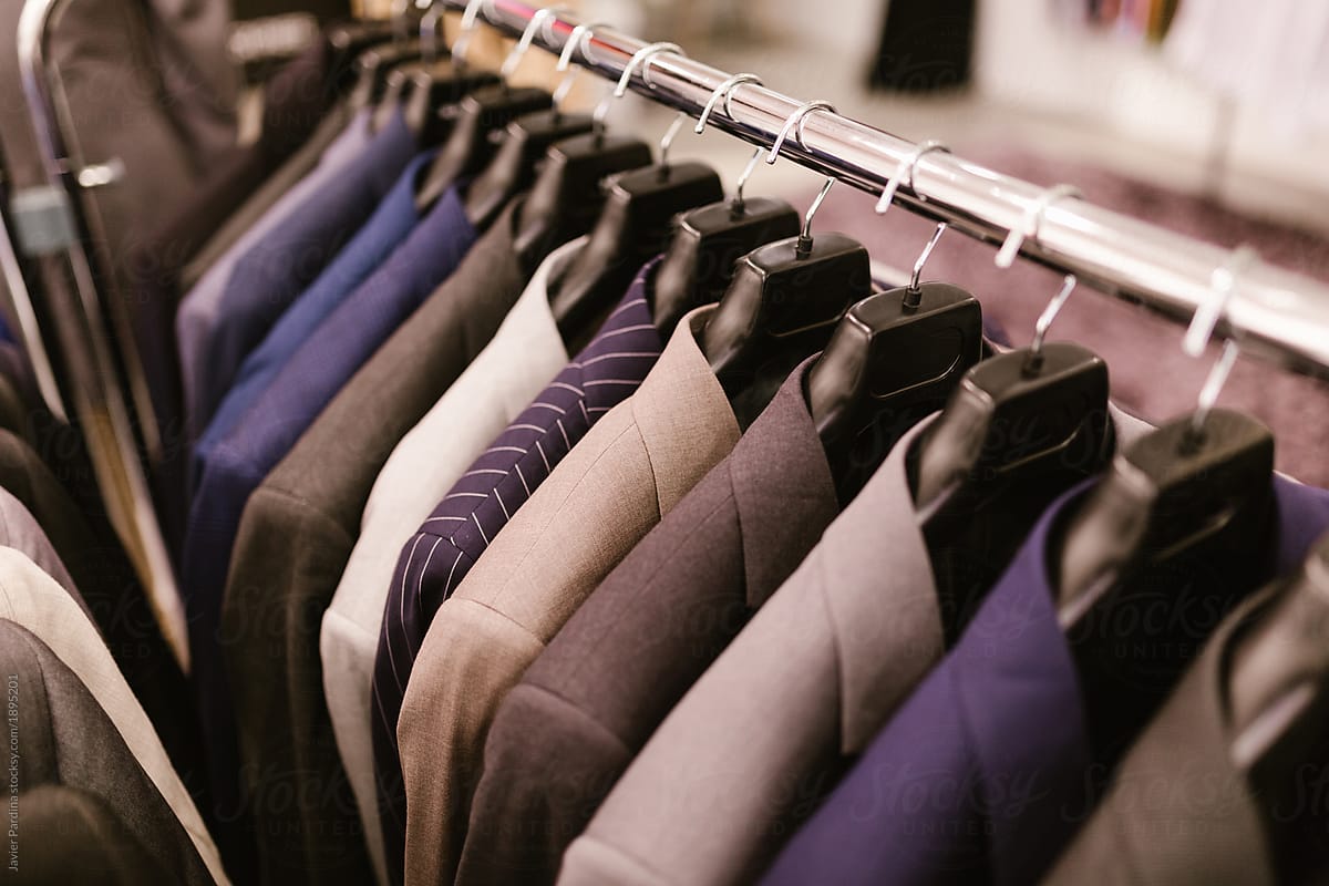 Men choosing suit at store