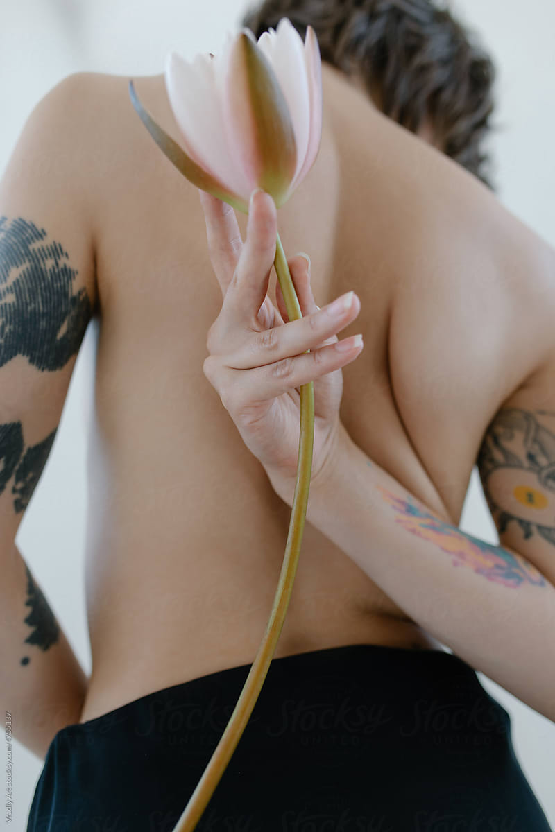 Woman from back with lotus in hand