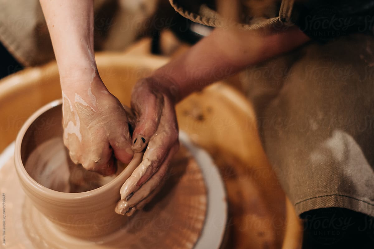Potter Forming Vessel on Pottery Wheel