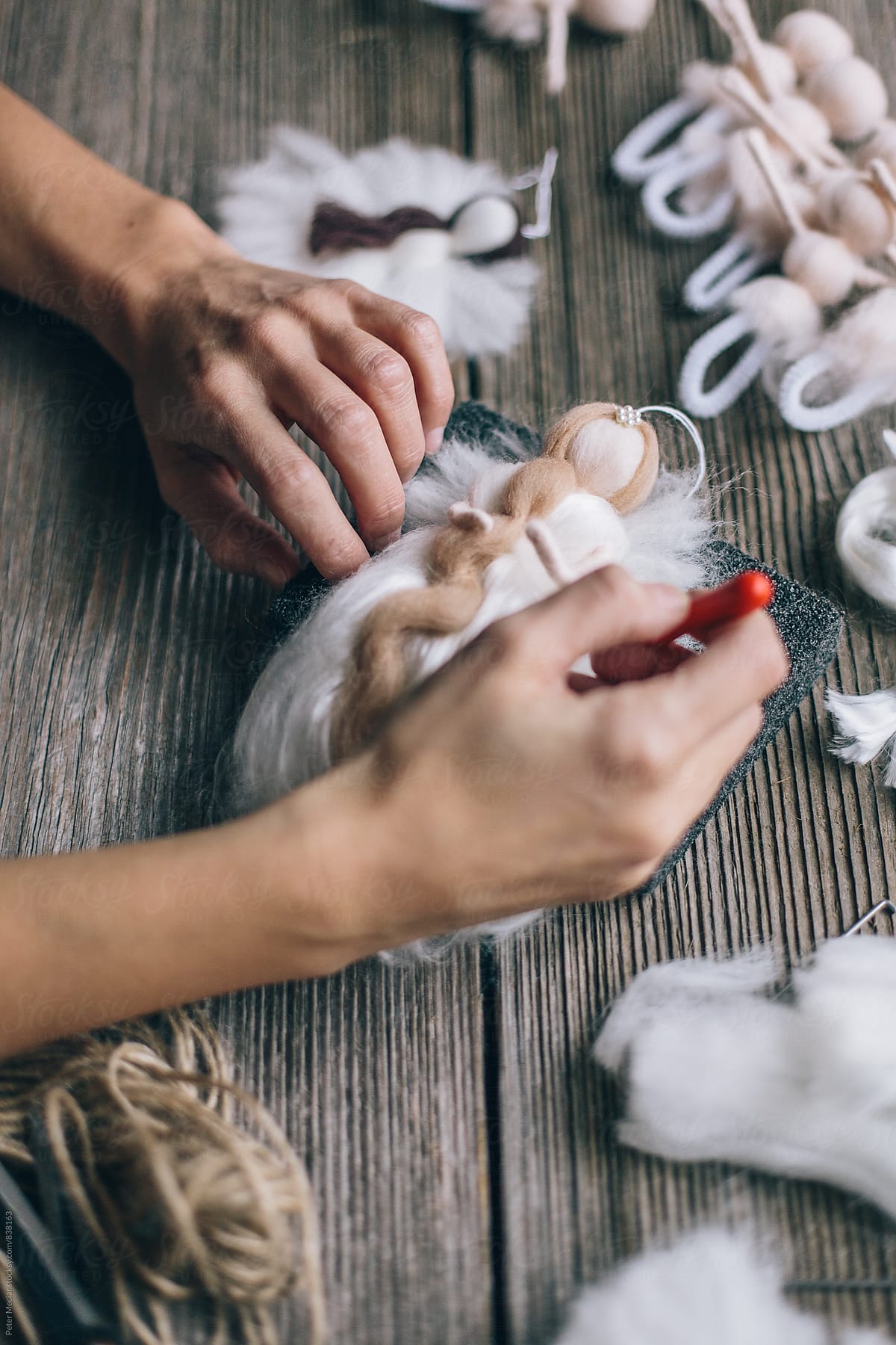 Handmade production of an angel made of merino wool