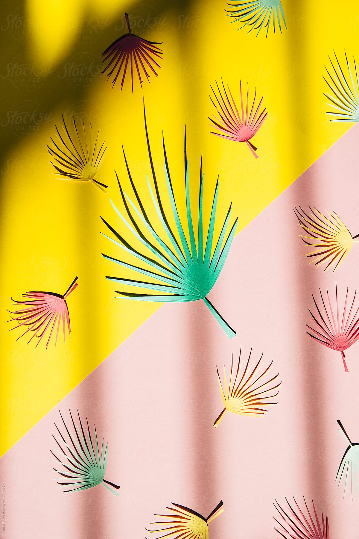 Palm leaf pattern on a pink and yellow diagonal background with shadow