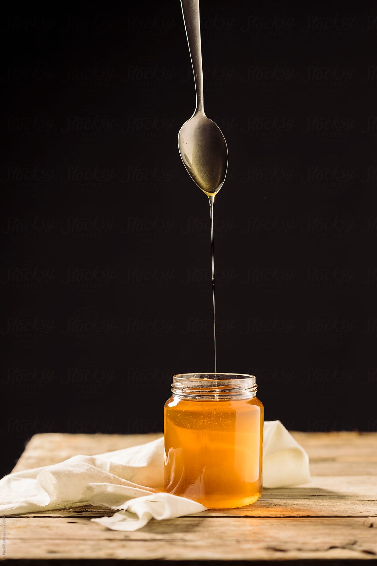 a spoon dropping honey