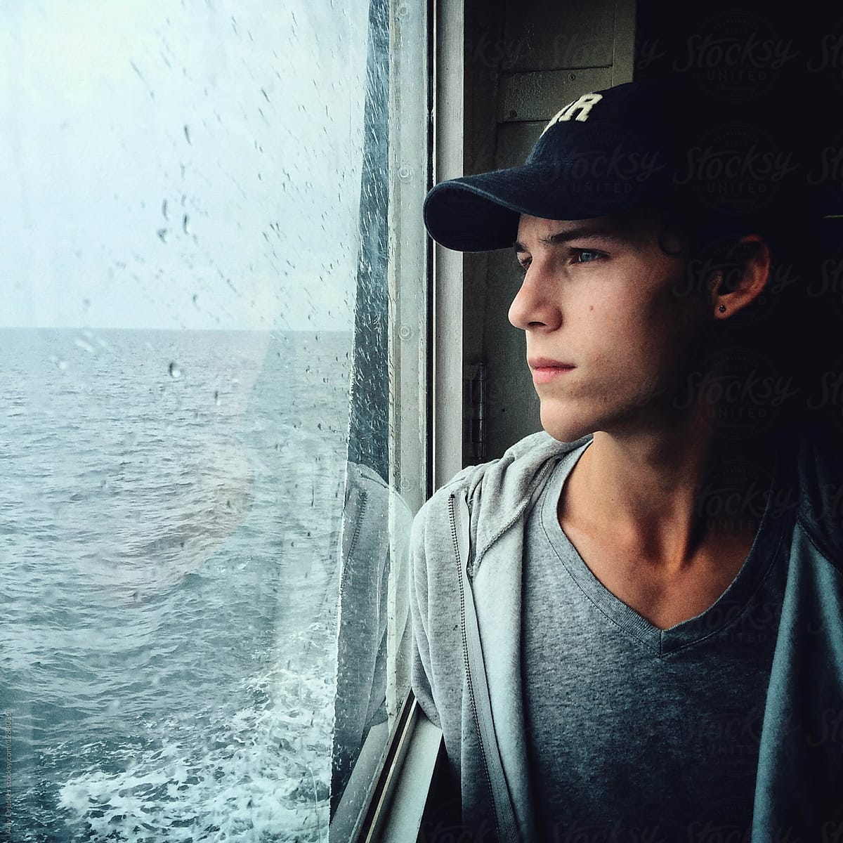 Teenage Boy Gazing out Ferryboat Window