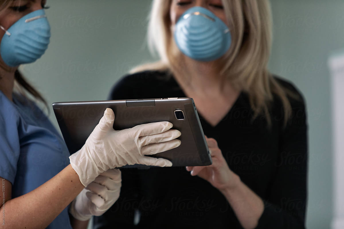 Exam: Doctor Uses Digital Tablet To Inform Patient