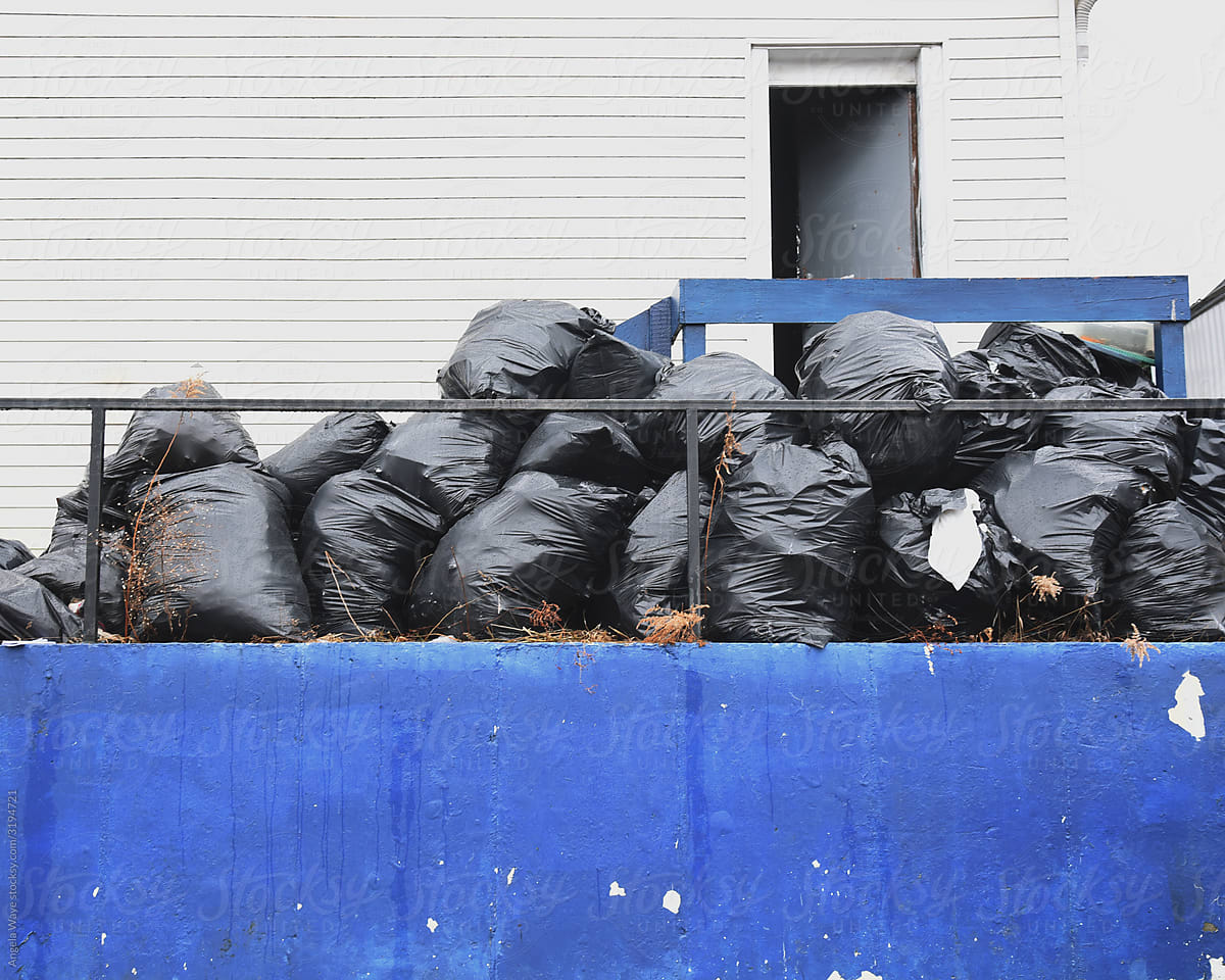 Garbage Bags Piled Up Outside Home Building