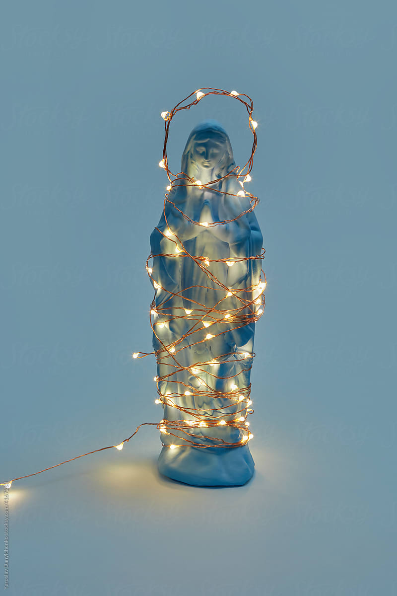 Virgin Mary statue with glowing garland