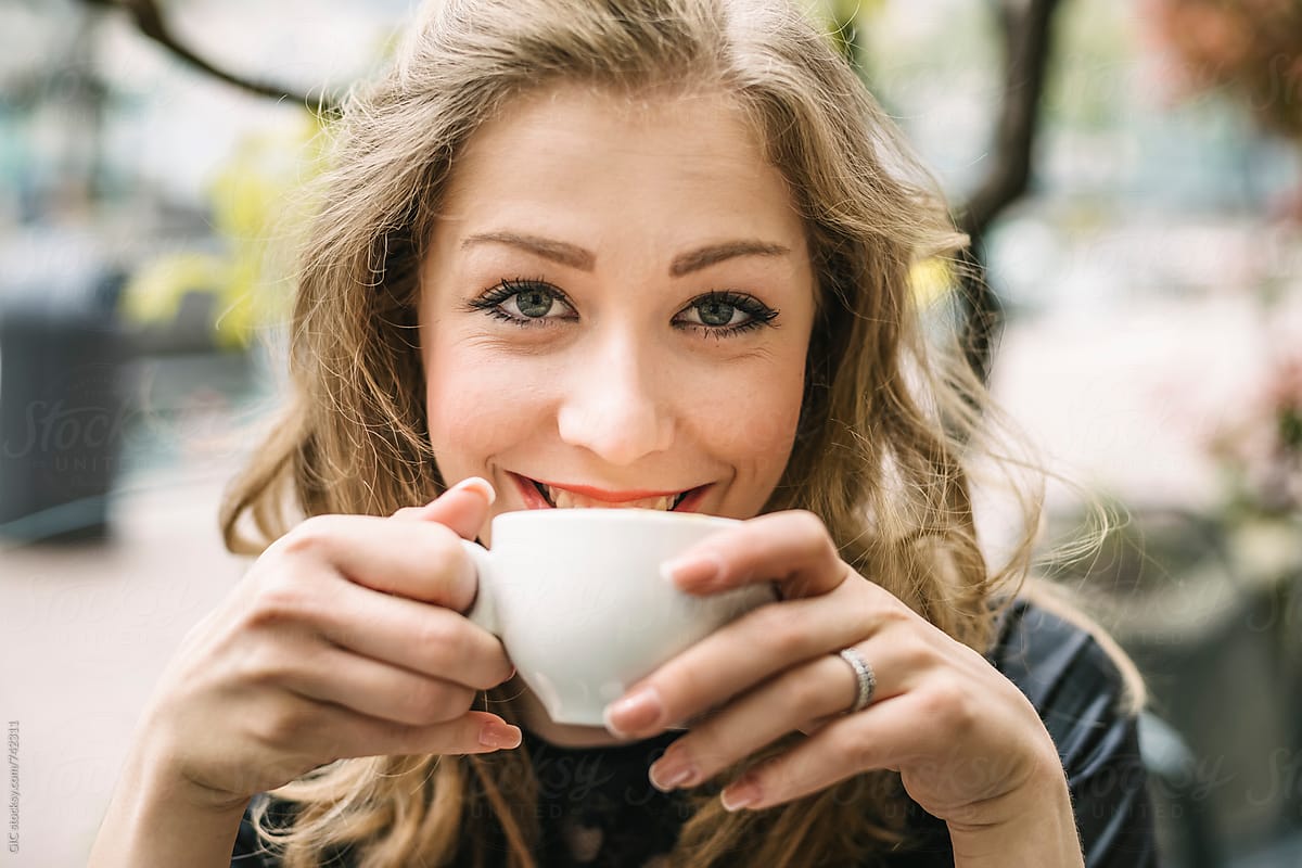Young beautiful blonde woman sitting at cafe