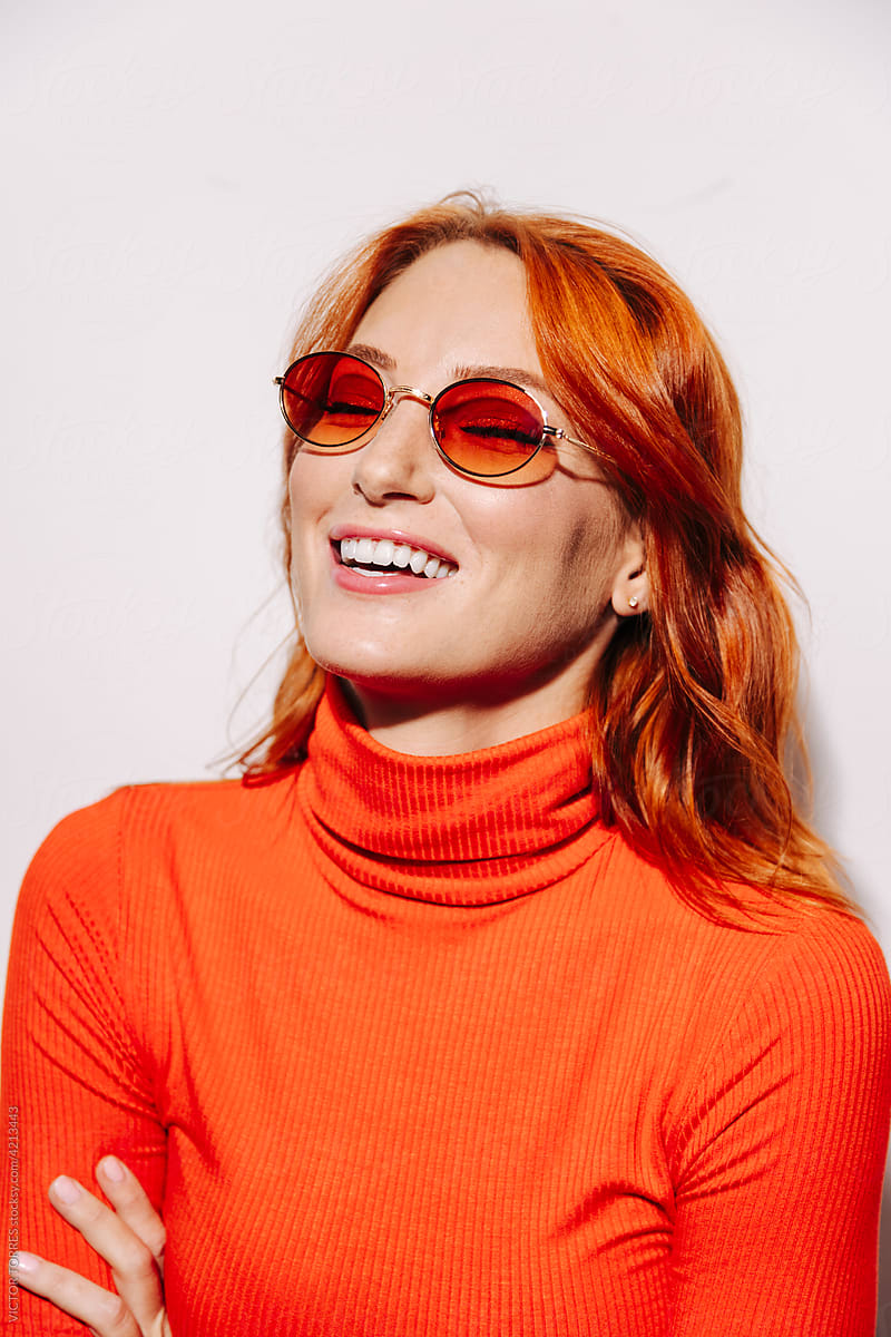 Happy stylish woman in orange sunglasses