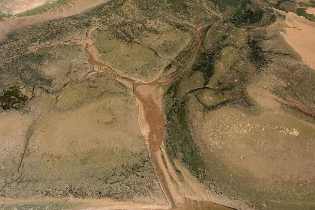 abstract arial view of a river reaching the ocean