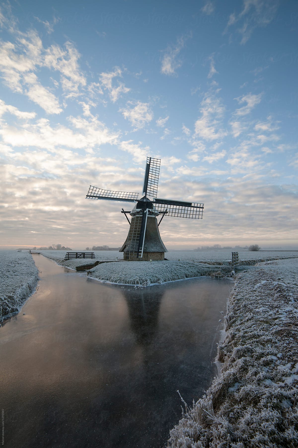Old Dutch windmill at sunrise in winter