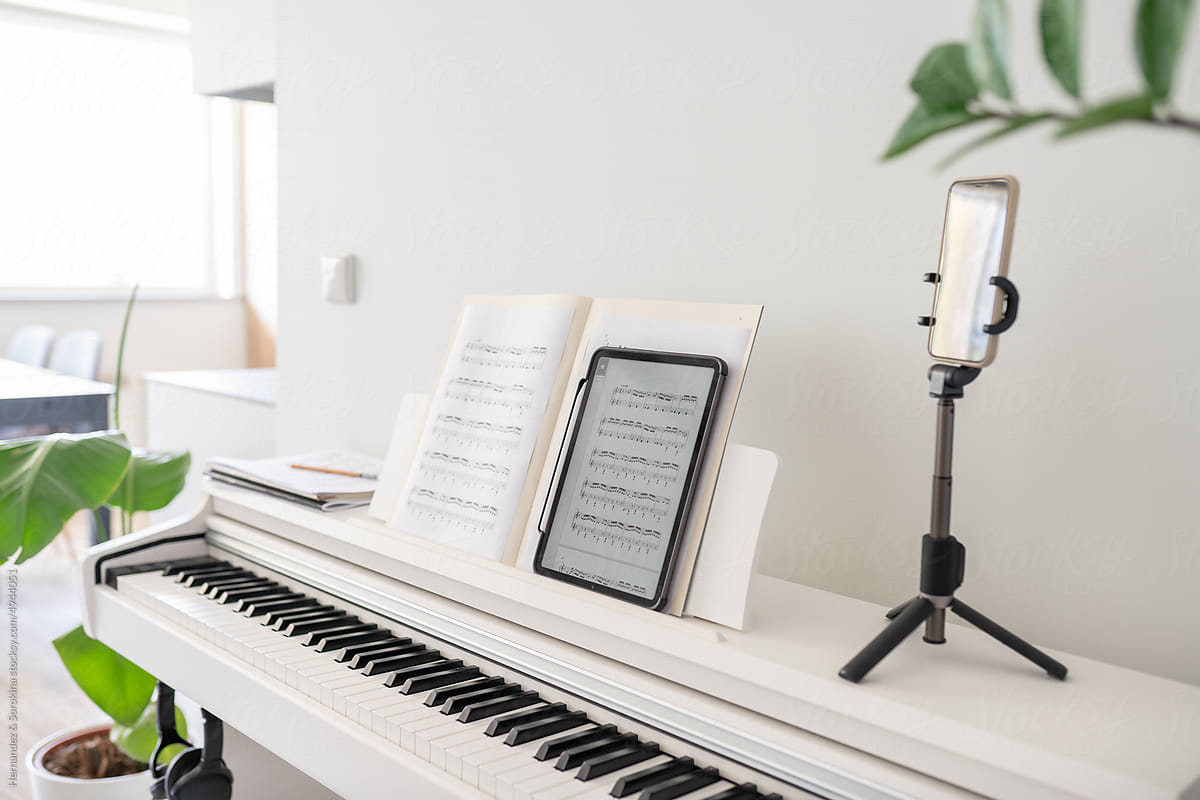 Tablet And Tripod With Phone On Digital Piano