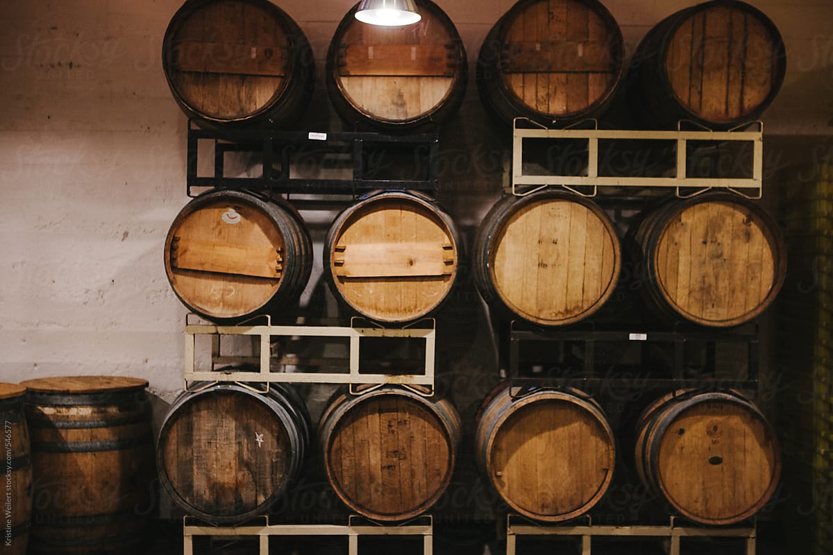 Wooden wine barrels stacked in a cellar
