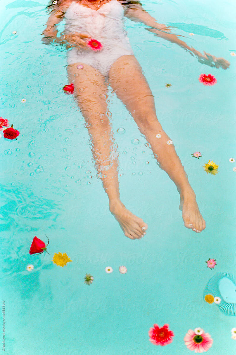 Woman in pool with flowers