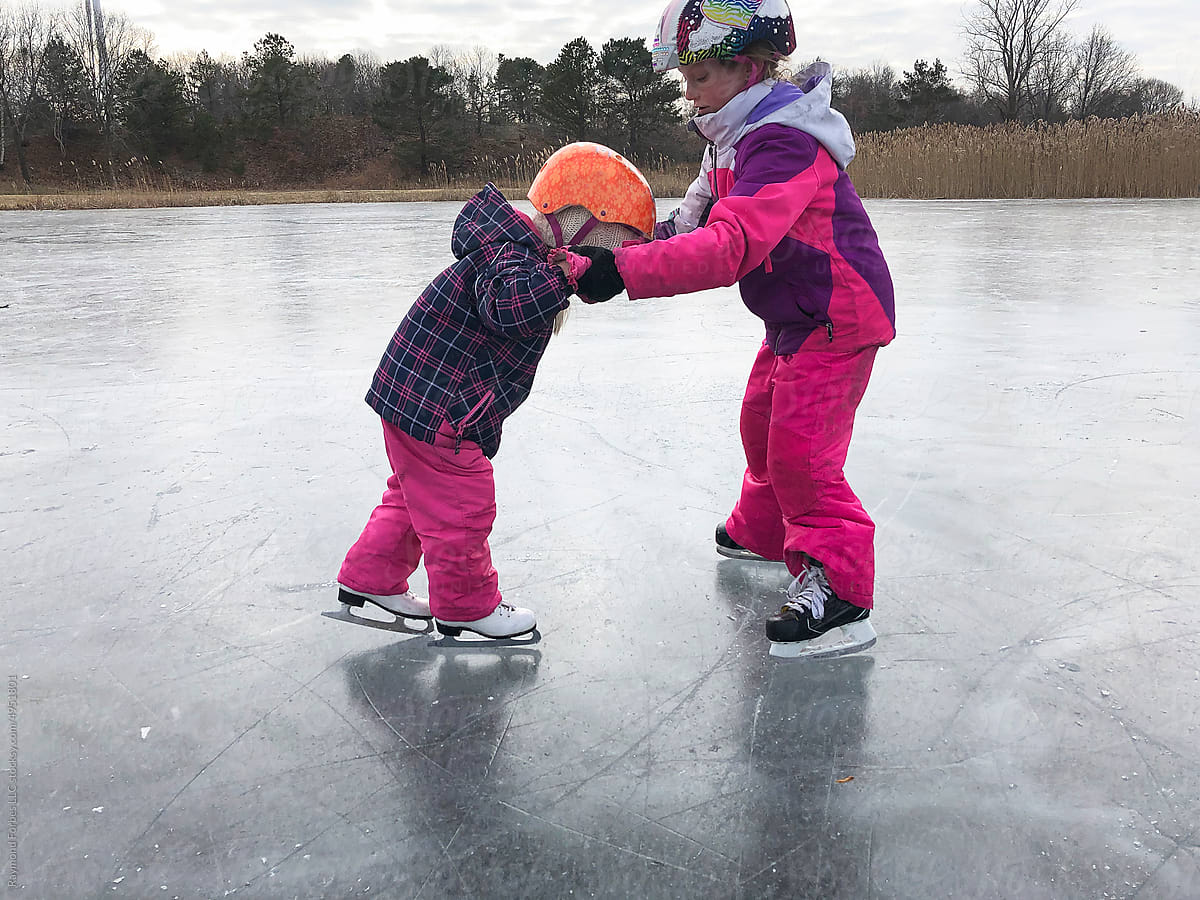 User-generated Content young girl getting skating lesson from sister