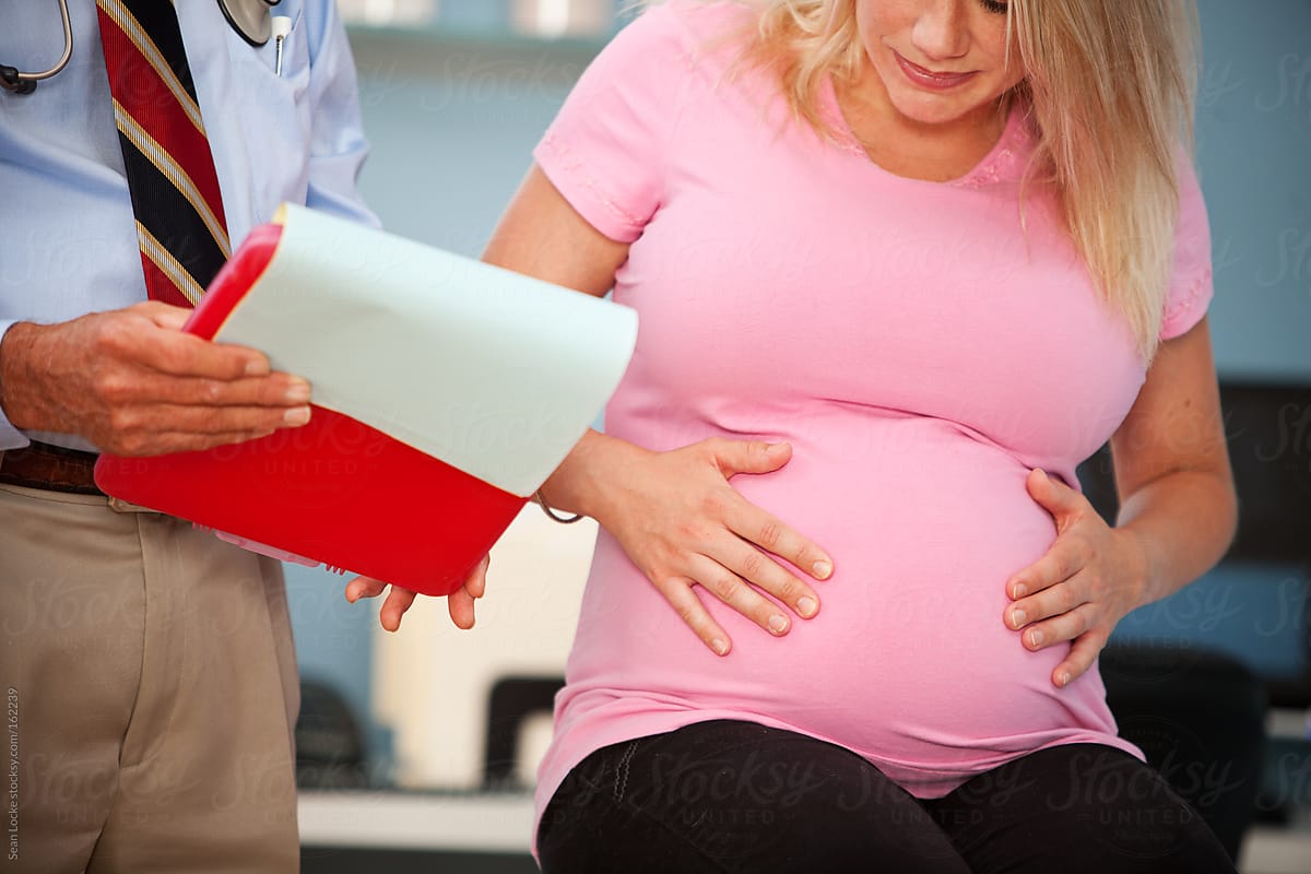Exam Room: Pregnant Woman Holds Tummy