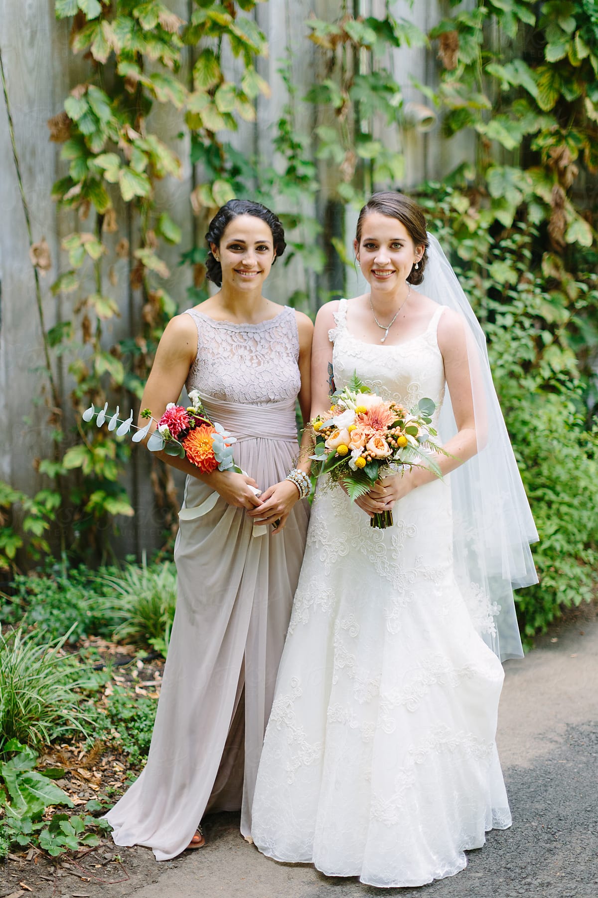 Bridesmaids Holding Bouquet Outdoors