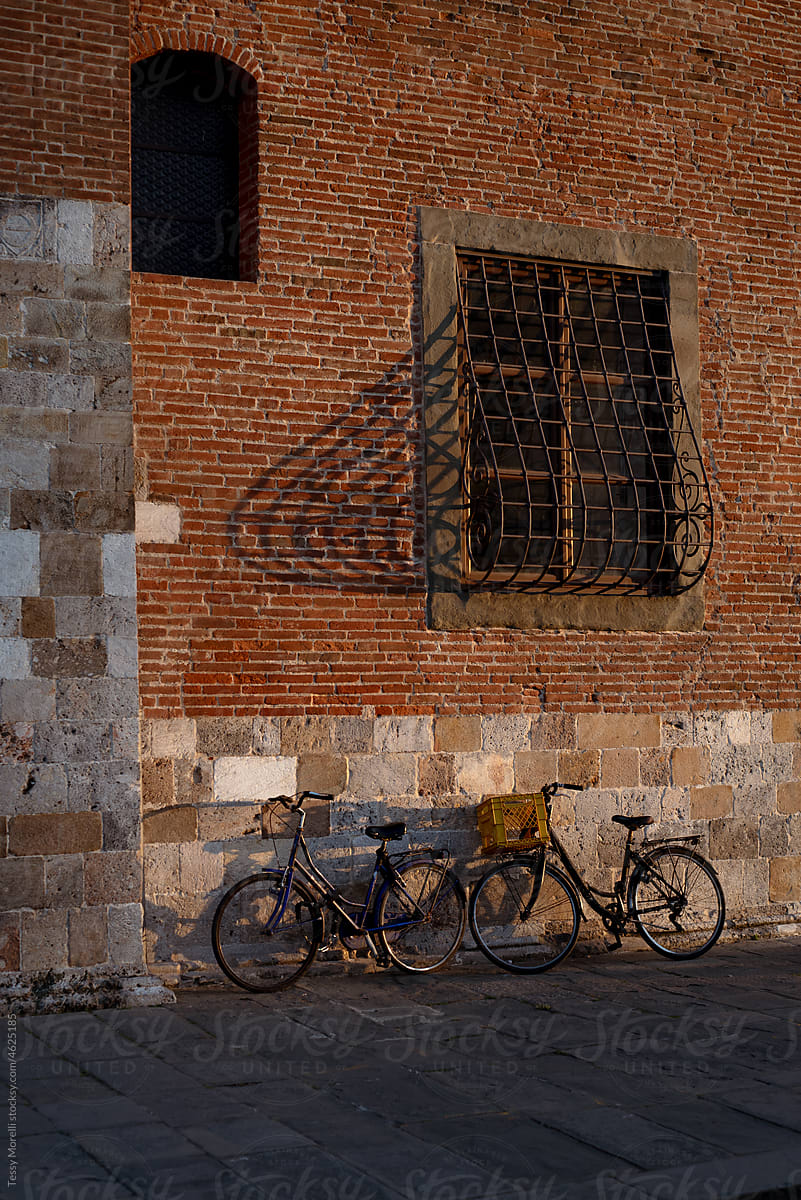 Pisa, Italy stone and brick ancient walls and bikes