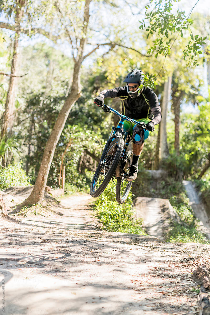 Mountain Biker Catches Air on Trail Jumps