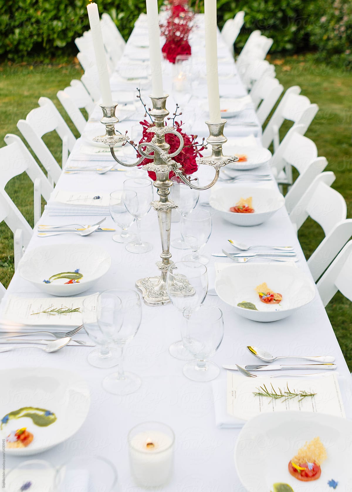 Fancy set up of white themed outdoor dinner party