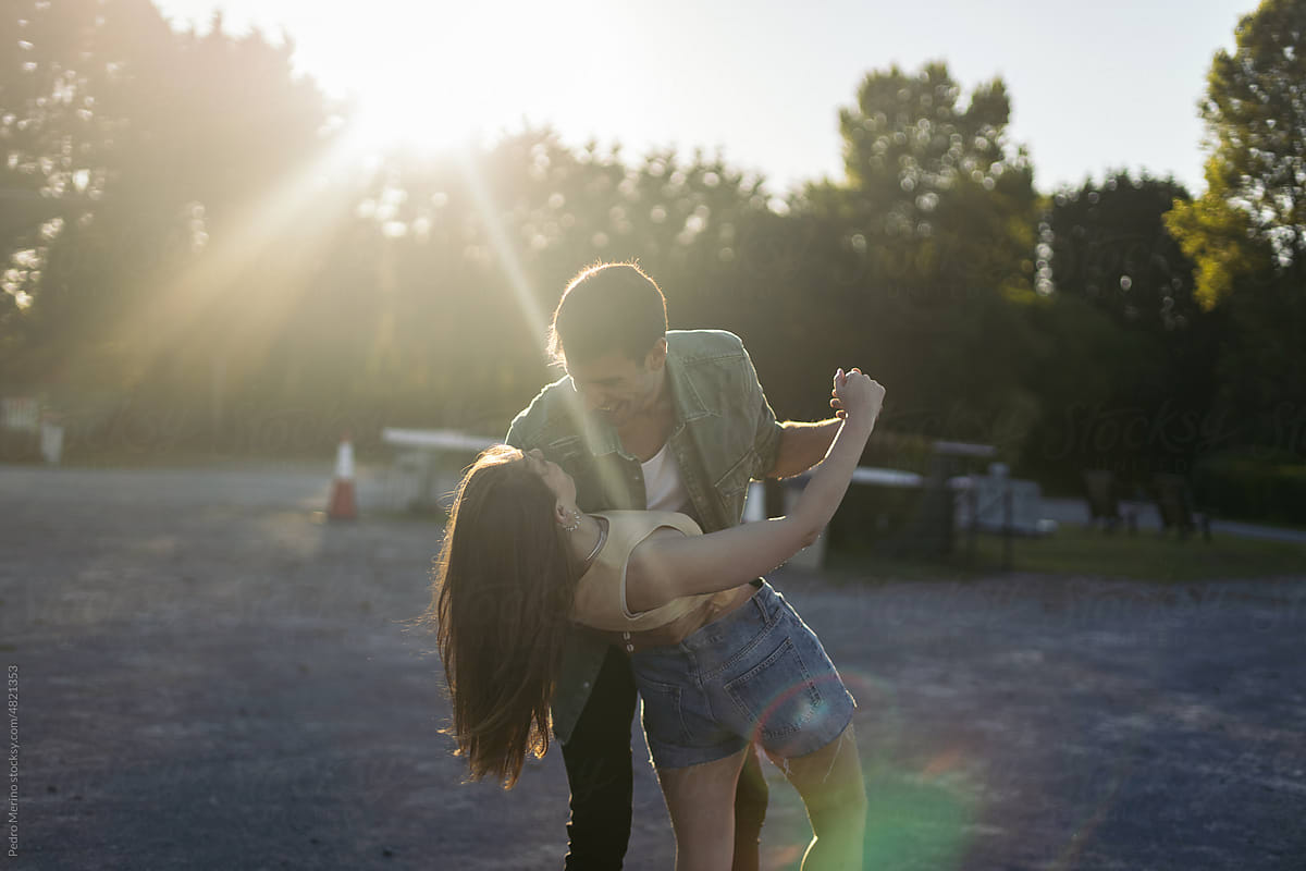 Couple dancing at sunset at the drive-in cinema