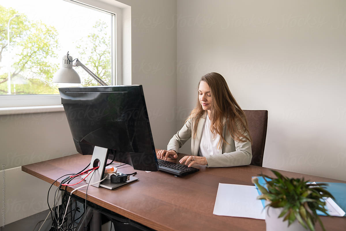 Woman Using Computer At Office