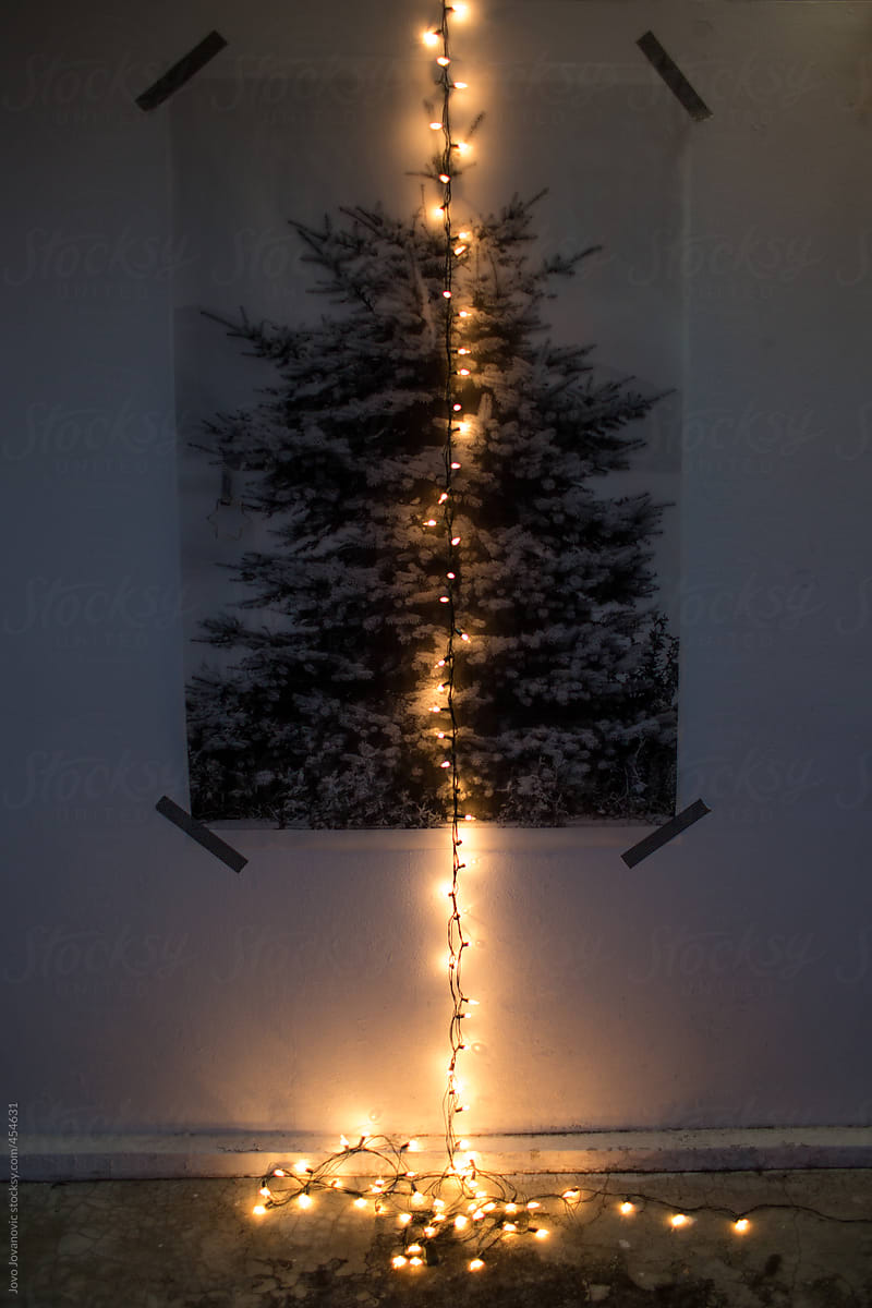 Printed Christmas tree on the wall and fairy lights