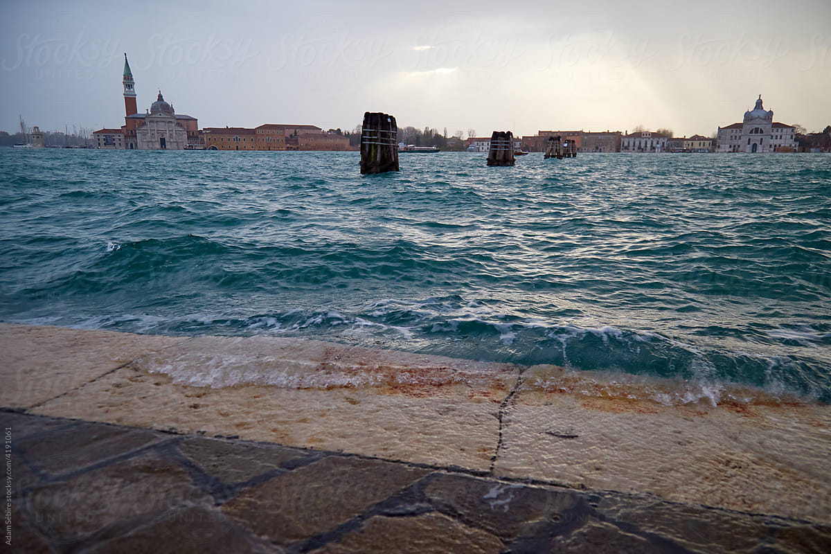 High tide floods wash over sea wall in Venice, Italy