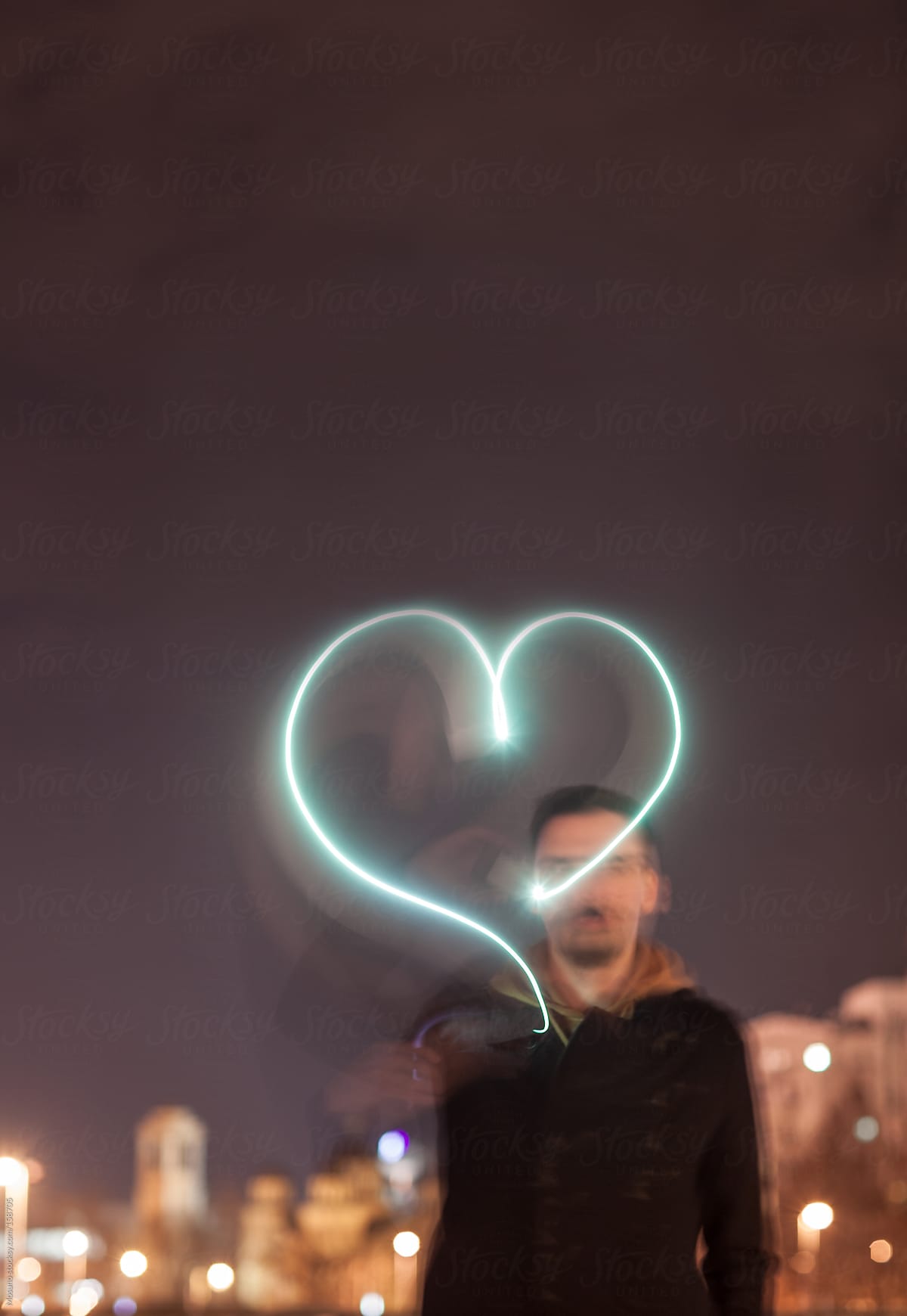 Man Drawing Light Heart in the Air