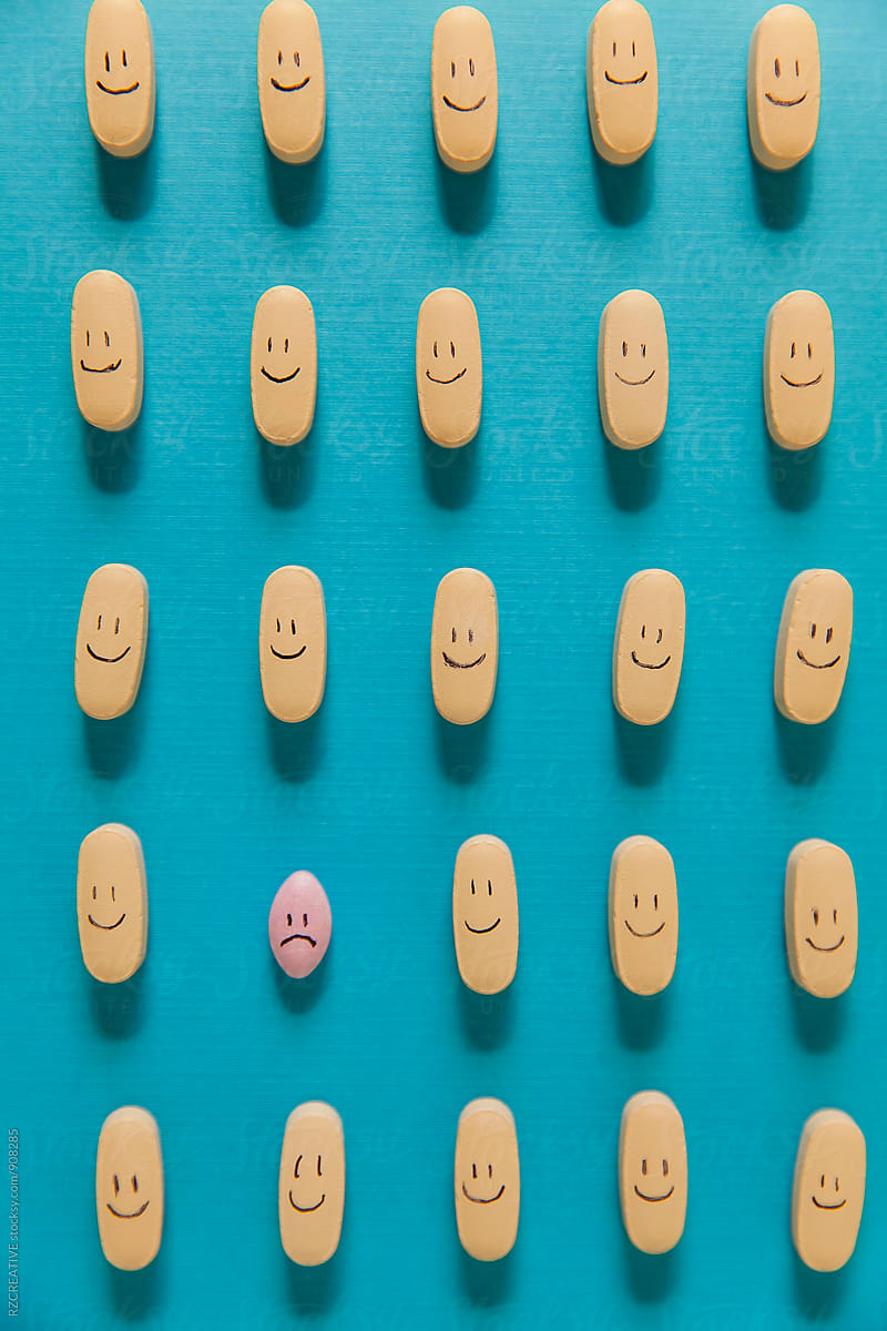 An unhappy pill among a line up of happy pills.