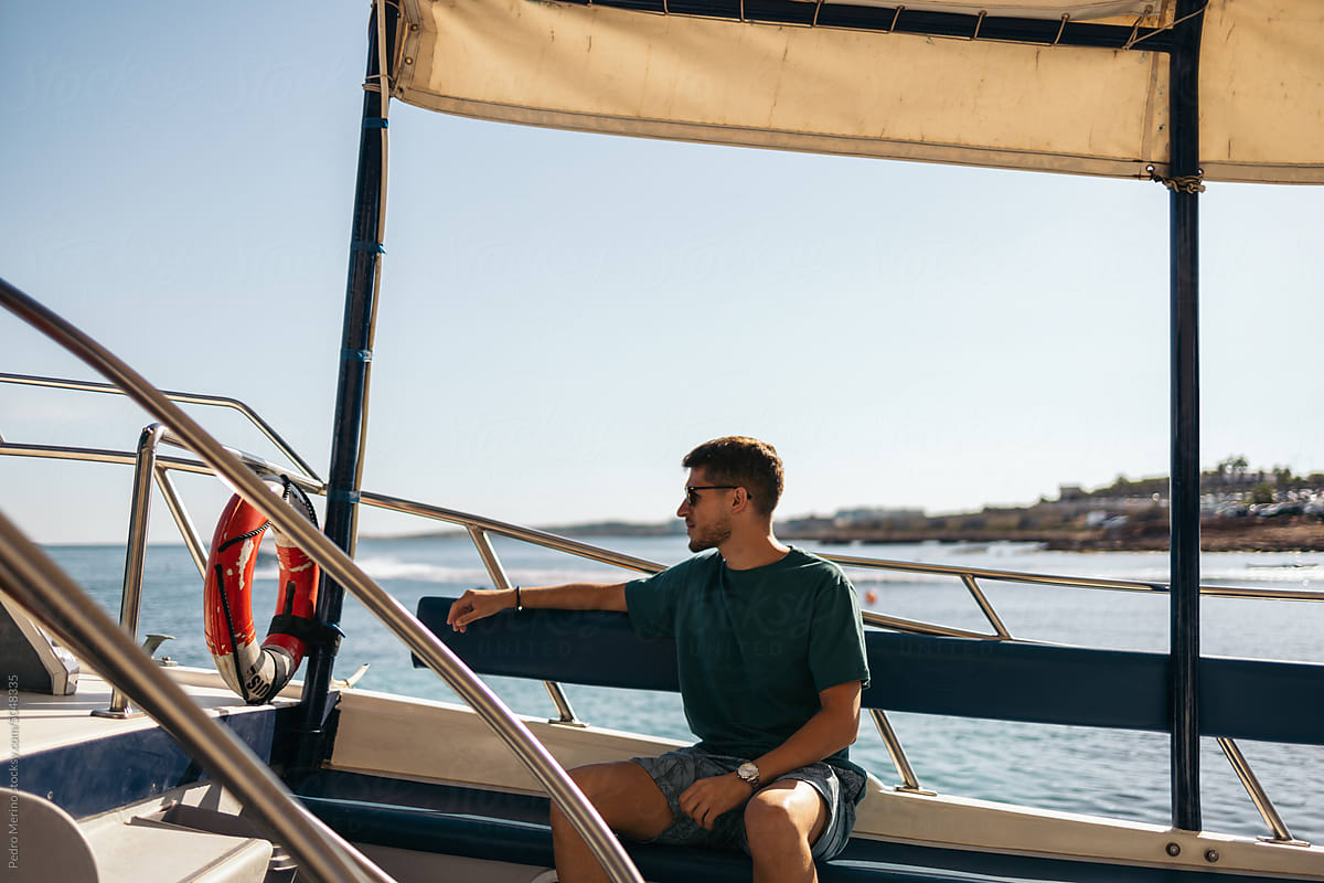 Young man traveling by boat to the Blue Lagoon in Malta