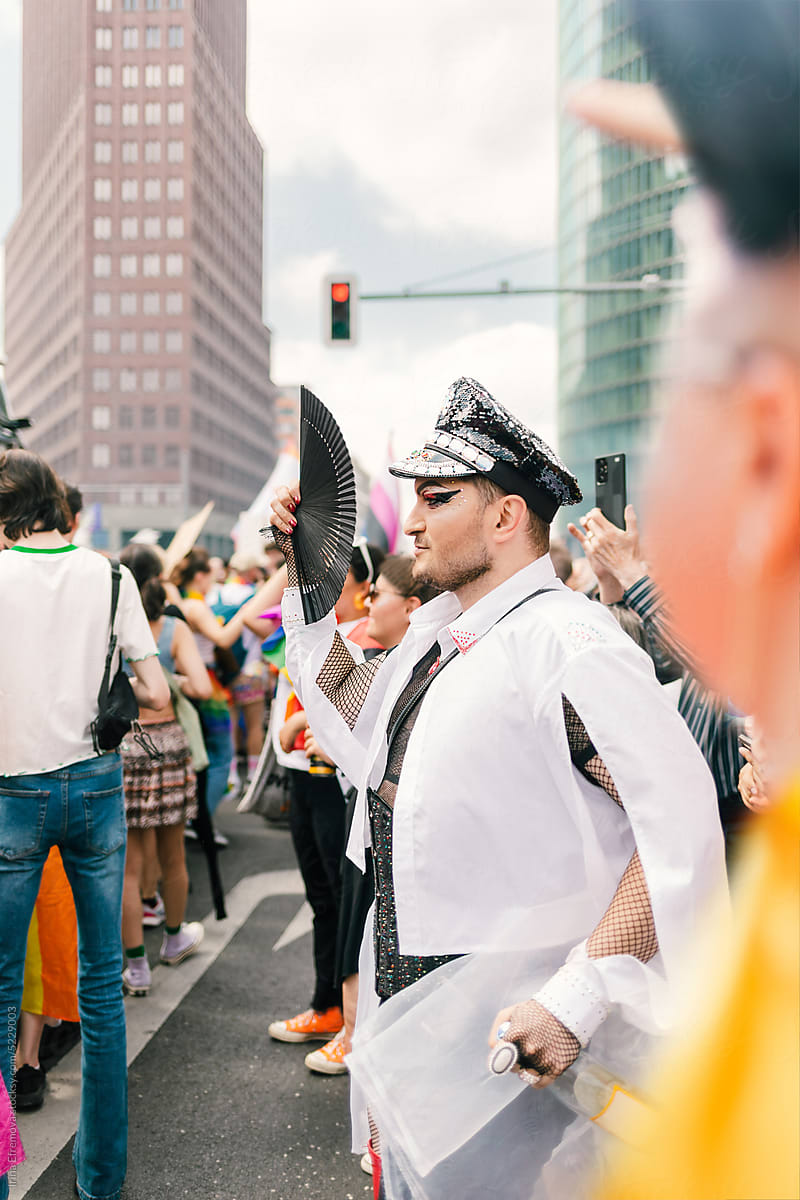 Voguing glam officer in Red heels marching at pride