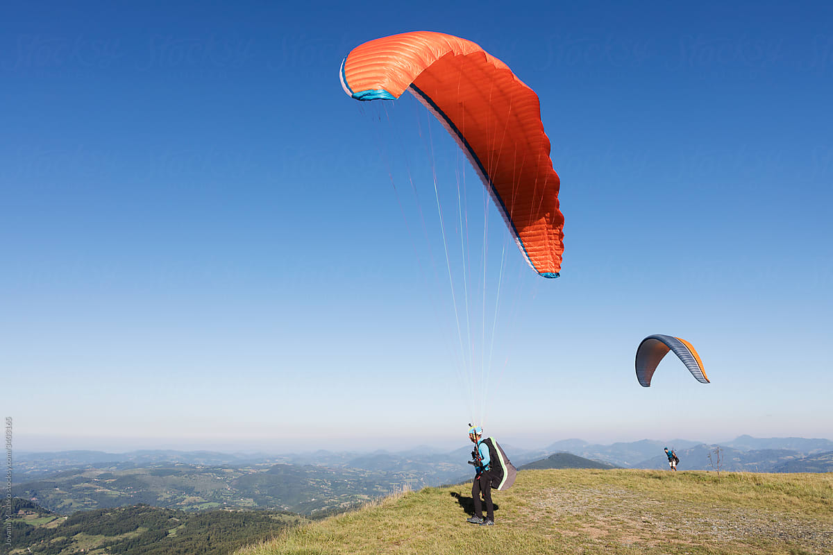 Friends paragliding together in nature