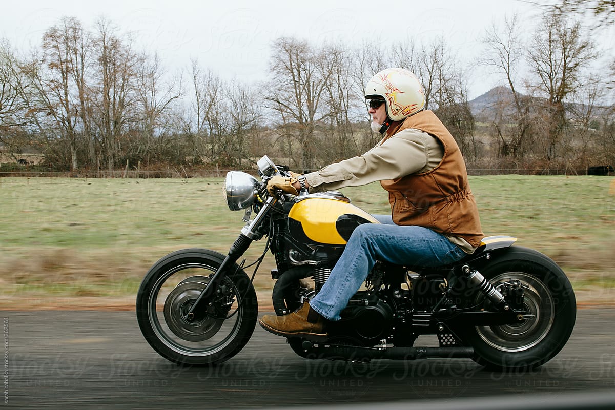 Man Rides motorcycle on road