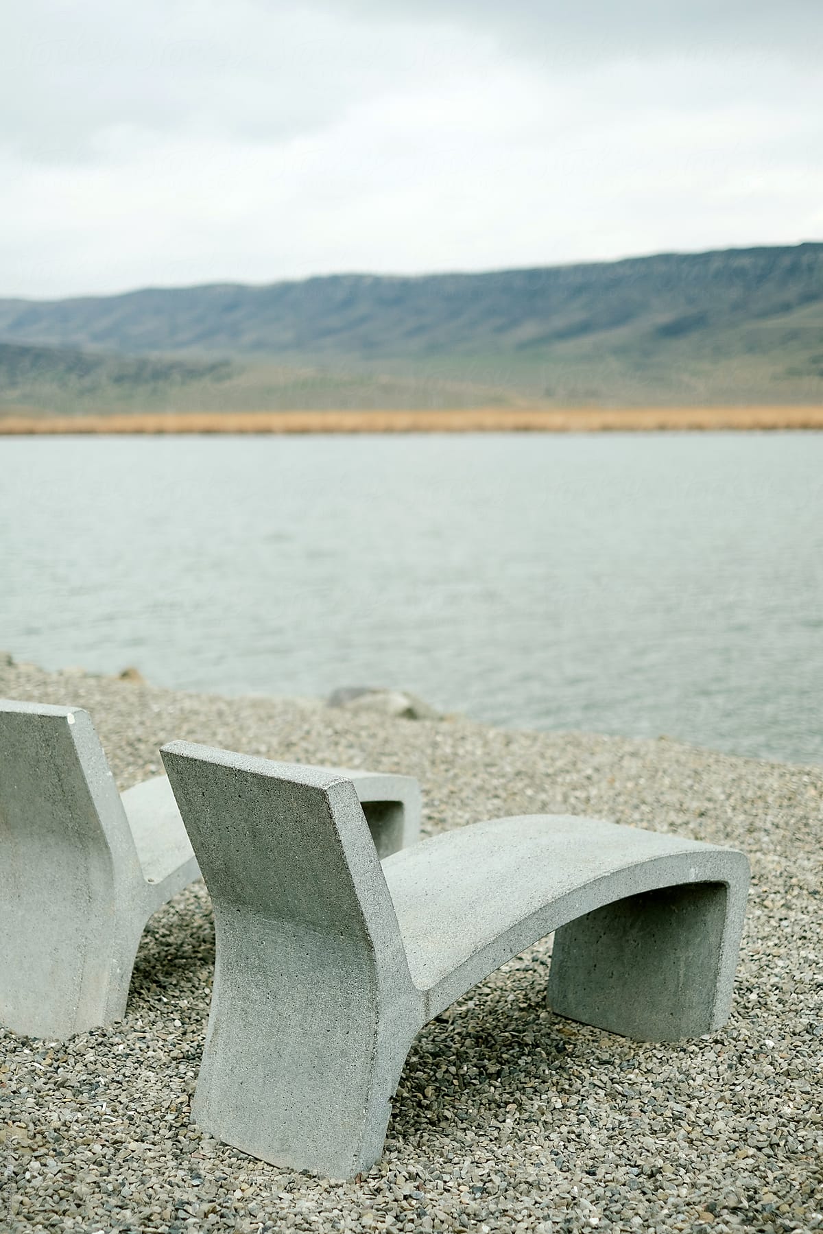 Concrete bench against the background of a beautiful mountain landscape and a lake